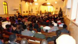 The Sudanese congregation seated inside the church