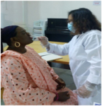 One of the dental nurses inspecting the mouth of a patient