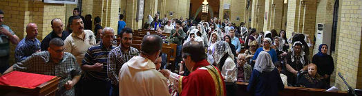 Receiving communion inside St George's Church, Baghdad
