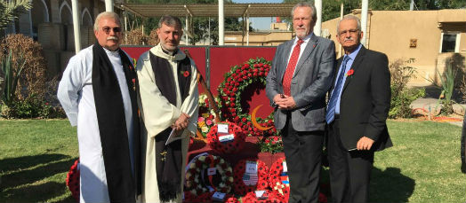 Archdeacon Bill Schwartz, Revd Faiz Jerges and John Banfields and Dawlat Abuna stand in front of the poppy wreaths