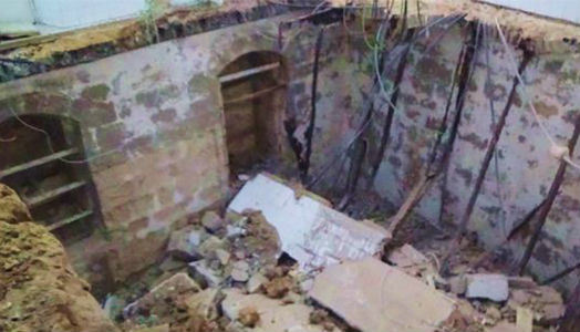 Looking down through the collapsed floor into the basement