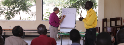 Bishop Mouneer collating the clergy's responses on a white board