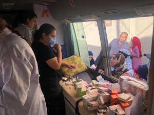 Serving patients through the pharmacy window of the bus