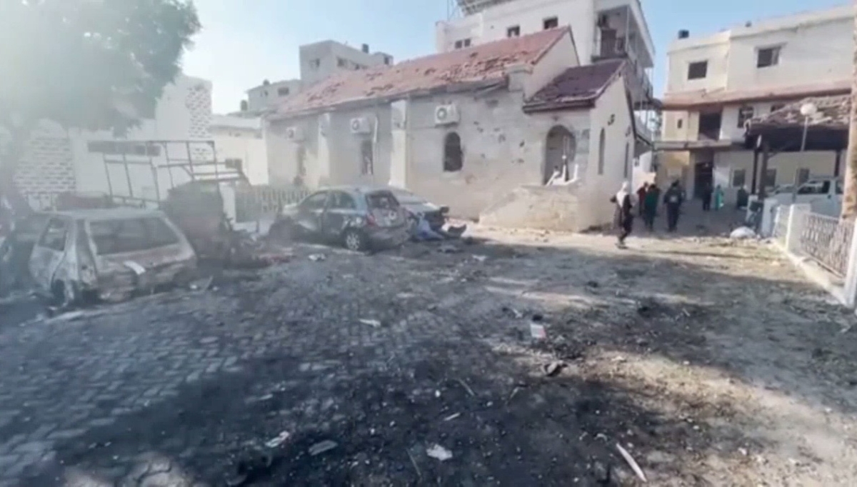 Damage to the al Ahli Hospital courtyard showing St Philip's church in the background