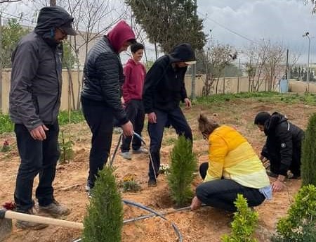 The students working hard planting the trees in  Al Wassieh in southern Jordan
