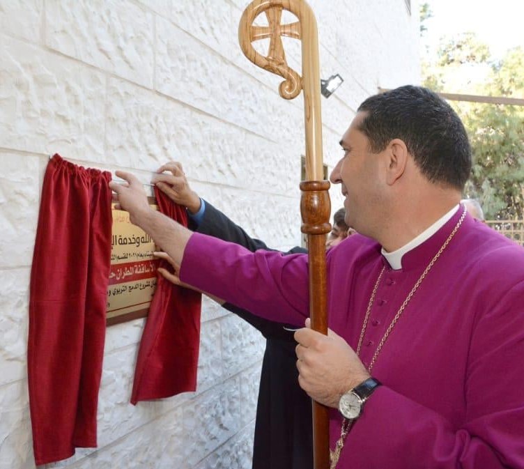 Archbishop Naoum holding his crook whilst unveiling the plaque commemorating the opening of the new floors