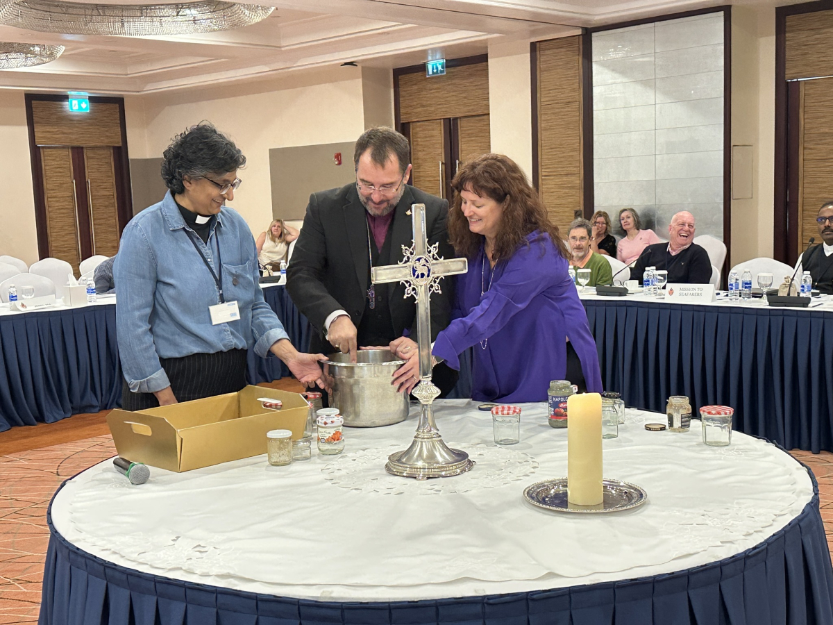 Bishop mixing the soils of the Diocese in a symbolic action at Synod.