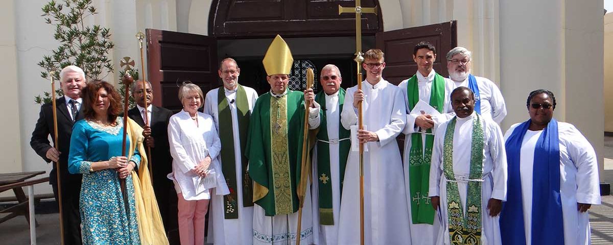 Canon Chris Butt with Bishop Michael Lewis and others outside the cathedral