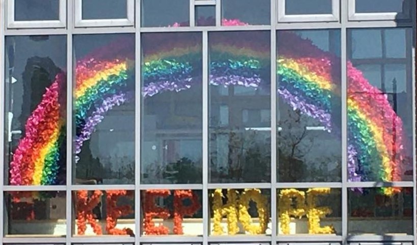 Large rainbow with words Keep Hope in church window