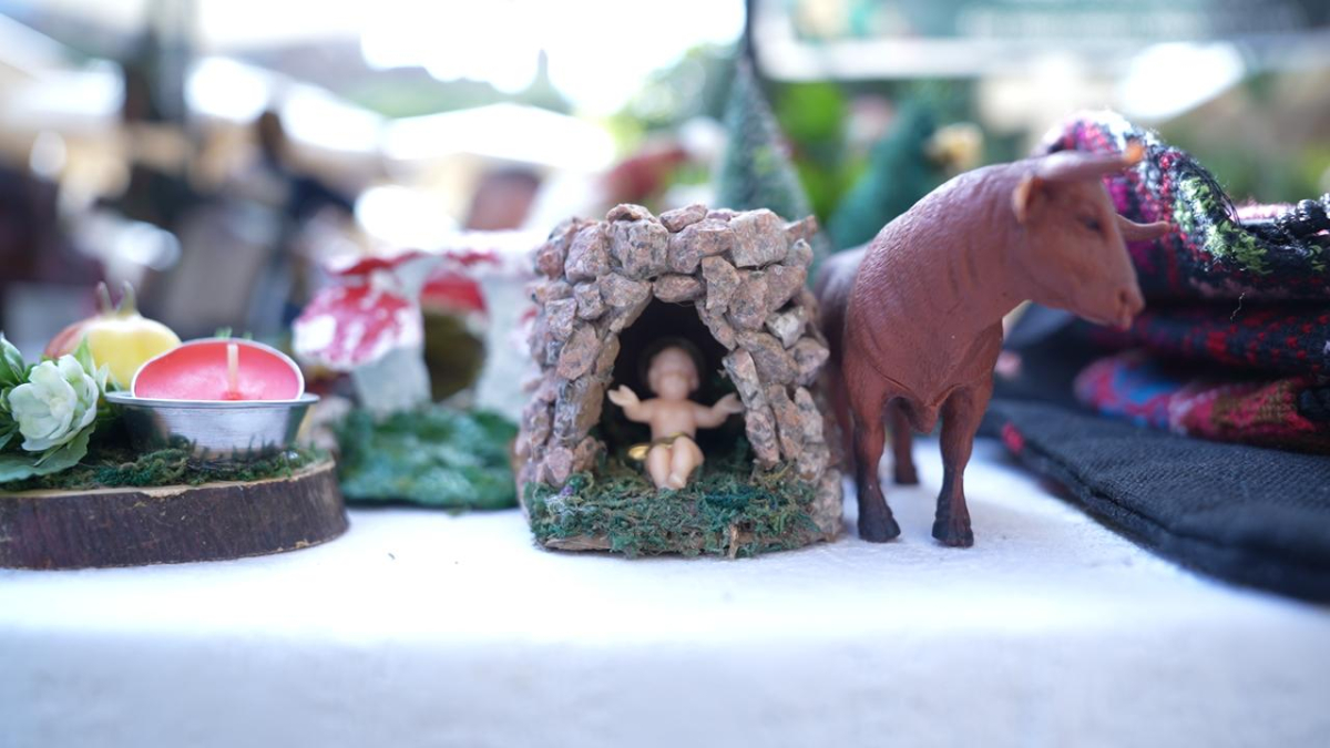 a ceramic nativity scene with a cow and a manger