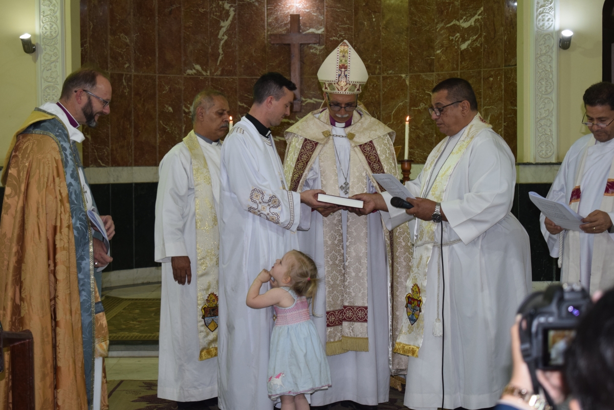 During the service Rev Joe's young daughter came forward and stood smiling up at Bishop Anthony as the bible is held by Rev Joe and Archbishop Samy