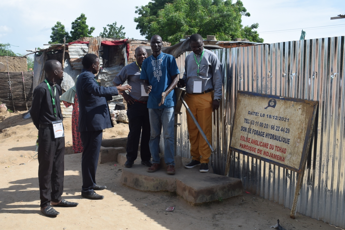 Church members gathered round the pump