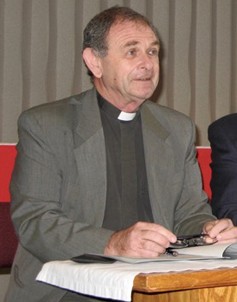 John Holdsworth sitting behind a desk