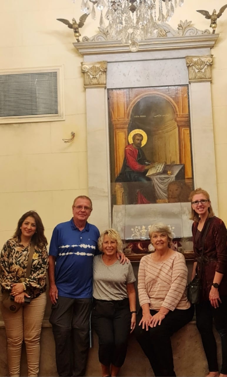 Group pose uner a picture of St Mark at St mark's Coptic Cathedral in Alexandria