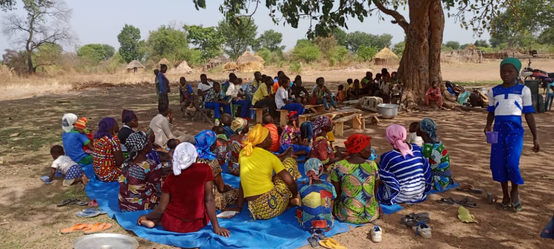 Church meeting under a tree in the village