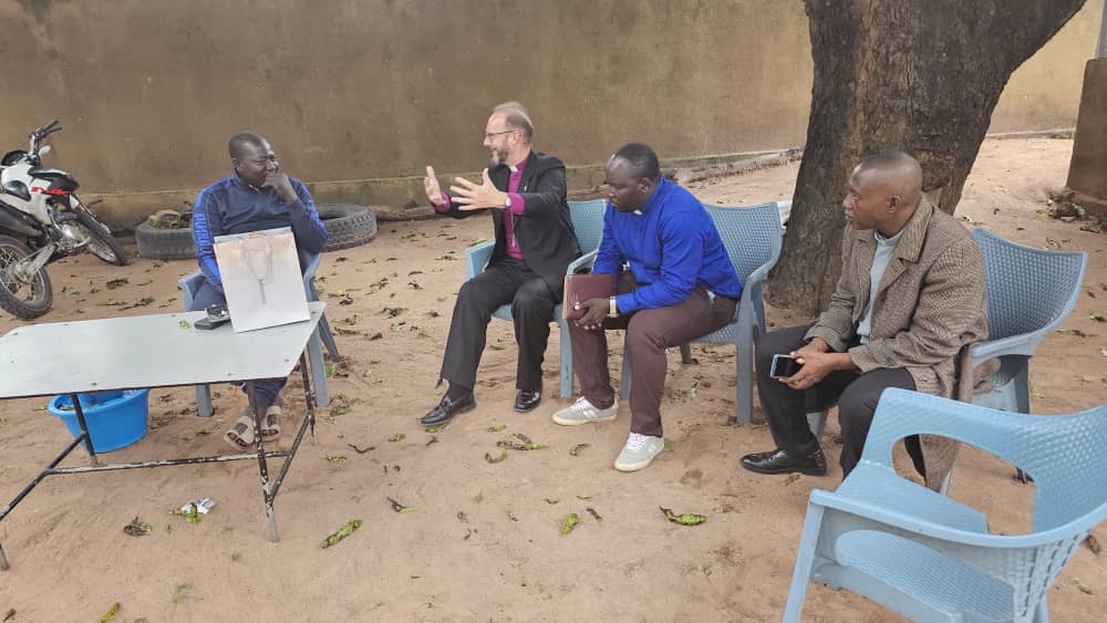 +Anthony in conversation with colleagues about the future of a plot they are visiting.