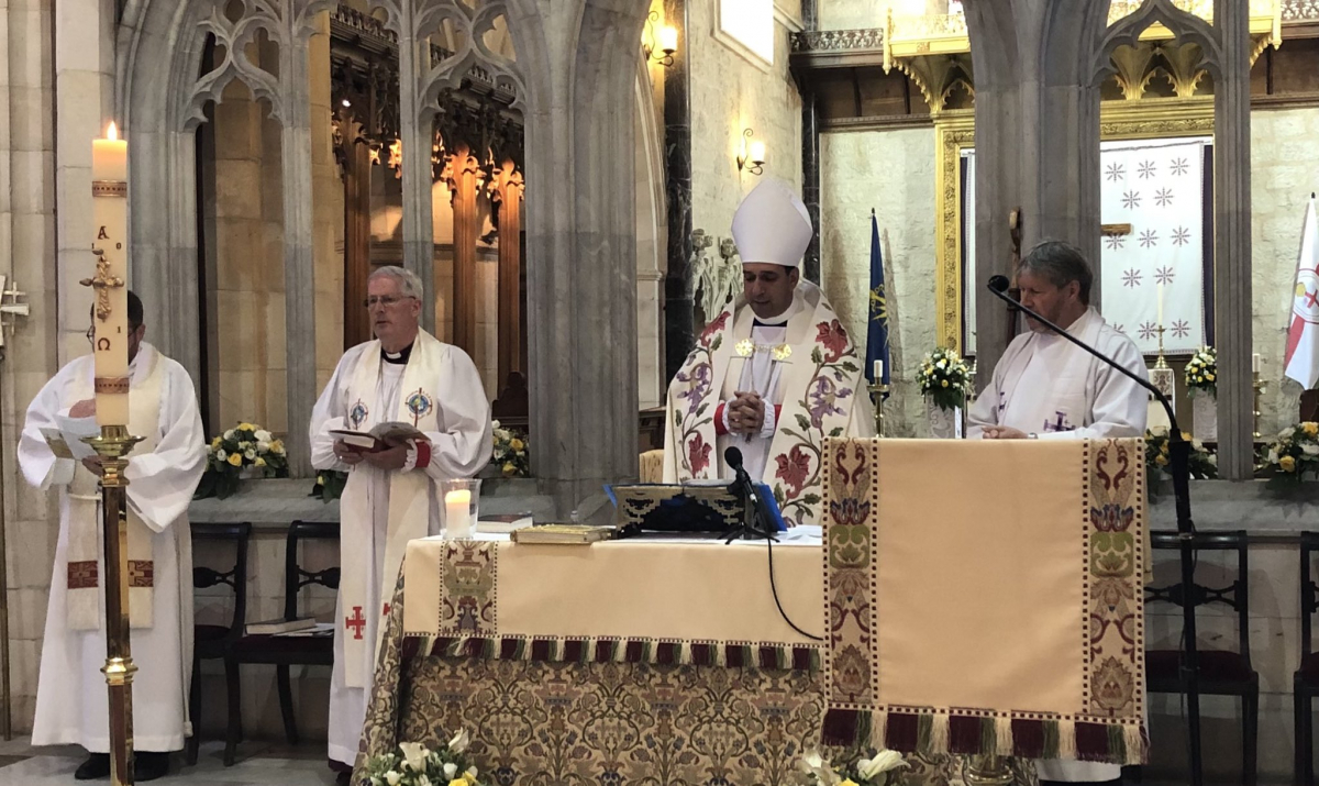 Installation service, Archbishop Hosam behind the alter in St George's Cathedral alongside the bishop's chaplain, Revd Don Binder