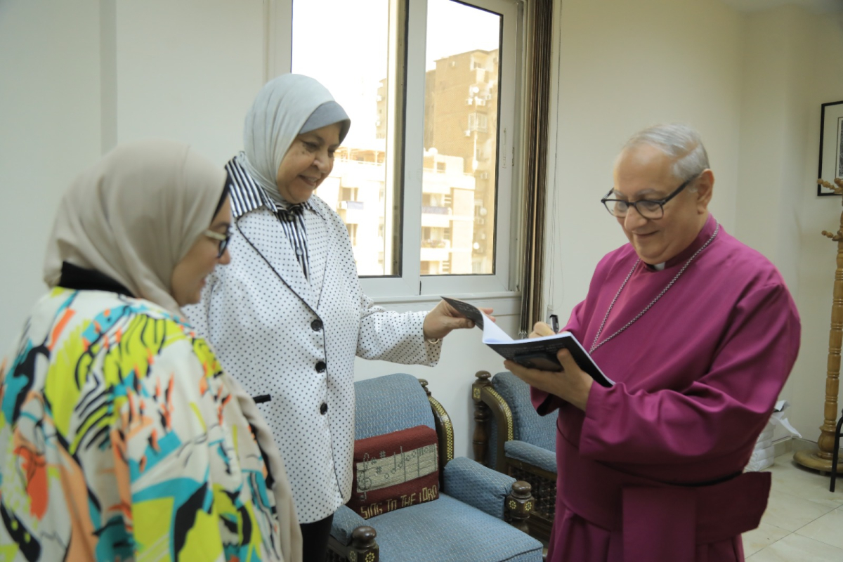 Archbishop Mouneer with two participants