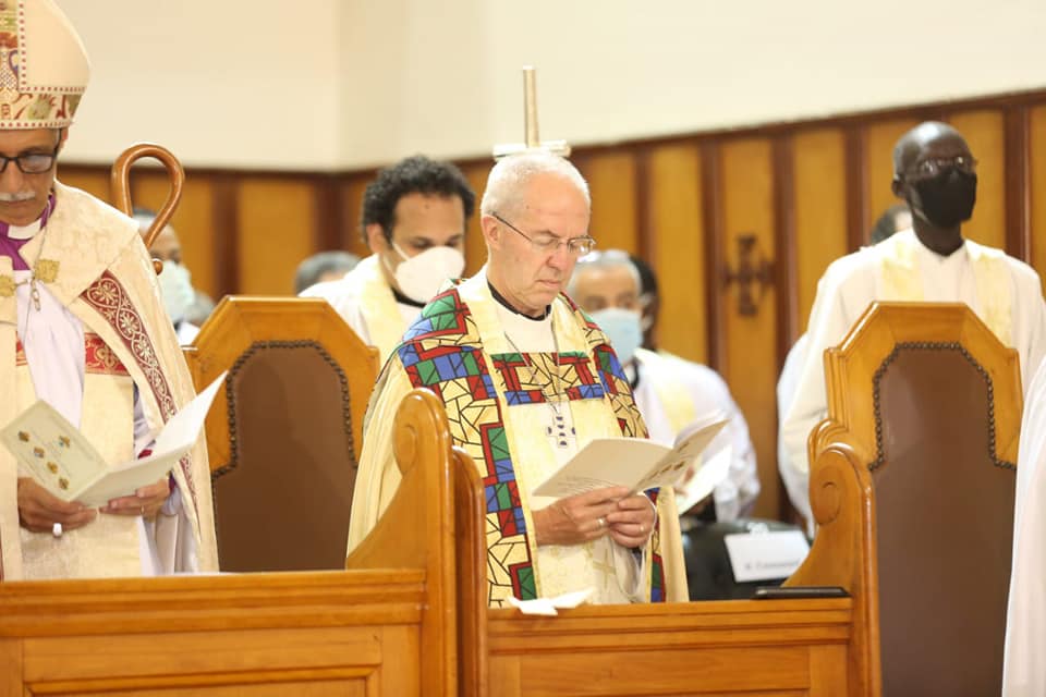 Justin Welby with head bowed in All Saints Cathedral pew