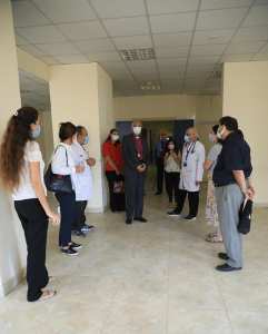 The Archbishop meeting the staff who are lining the corridor of the hospital