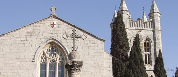External photo of the Cathedral with the cross statue in front of it