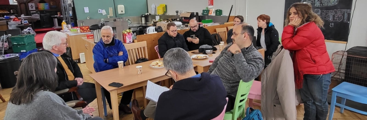 The Larder volunteers sharing coffee around a table in the community food centre
