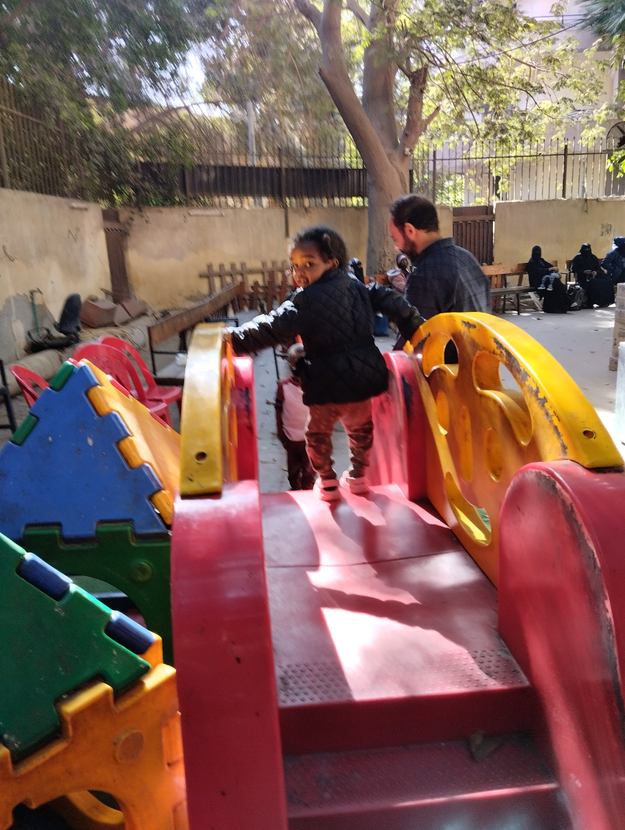 a child plays whilst waiting to be screened